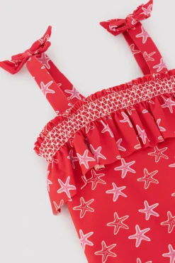 Bañador niña detalle volante estampado estrellas marinas rojo