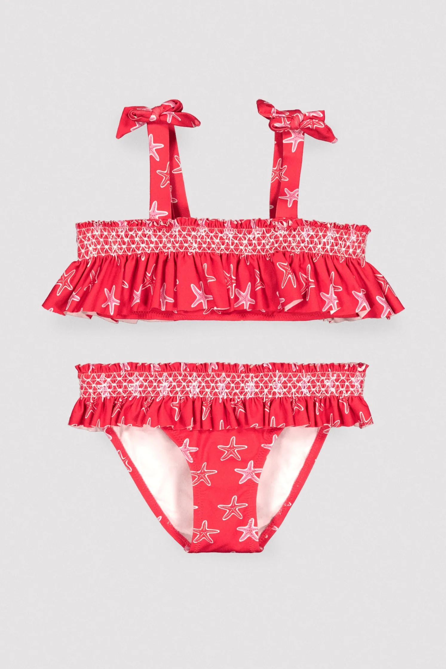 Bikini niña detalles volantes y nido de abeja estampado estrellas marinas rojo