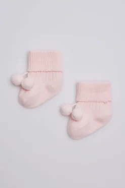 Calcetines canalé con borlas recién nacido rosa