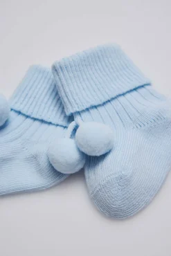 Calcetines canalé con borlas recién nacido celeste