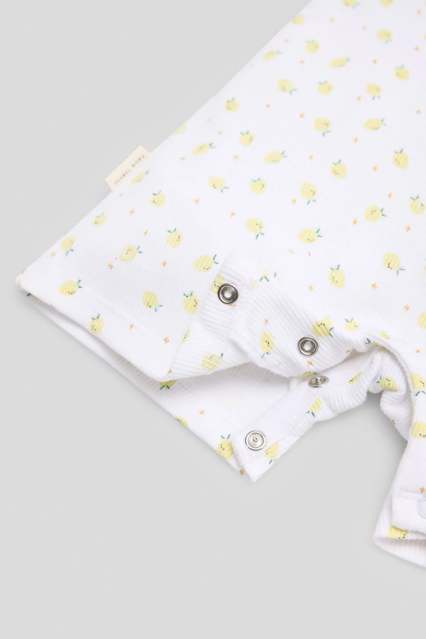 Peto bebé sin mangas estampado limones